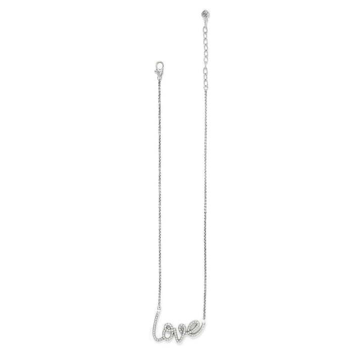 Brighton silver-plated necklace with cursive love script pendant accented with crystals and lobster clasp on a white background