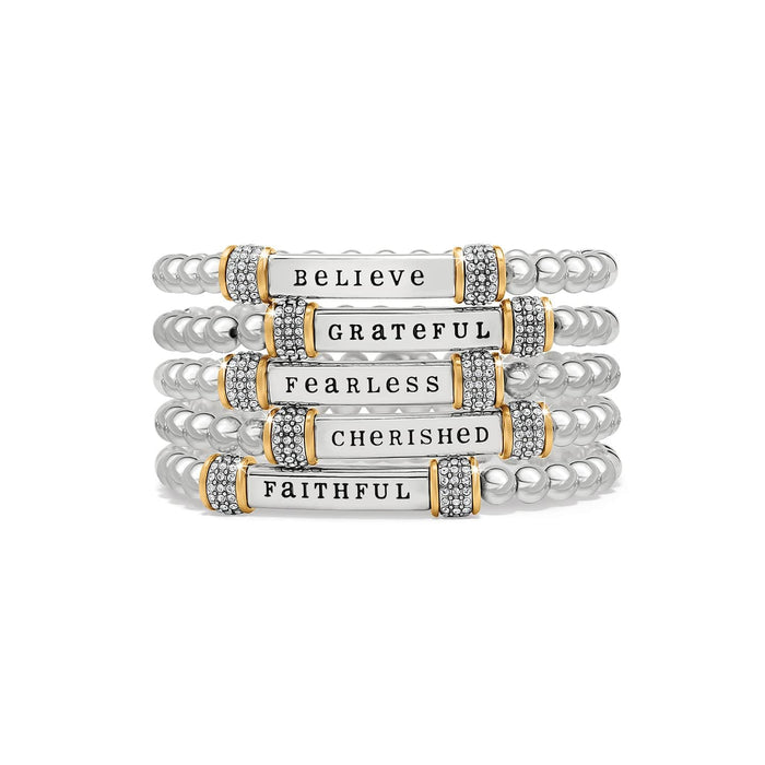 Brighton beaded bracelet stack with two-tone bars reading believe, grateful, fearless, cherished, faithful with crystals on a white background