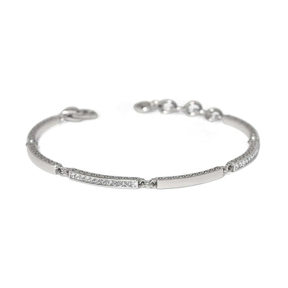 Brighton bangle bracelet with silver-plated finish, crystal-set bars, scroll engraving, and adjustable chain on a white background