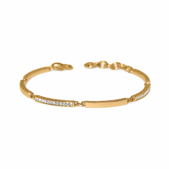 Brighton bangle bracelet with gold-plated finish, crystal accents, and engraved scroll detailing on a white background
