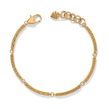 Brighton bracelet with gold-plated scrolled bar links, heart-shaped clasp, and adjustable chain extender on a white background