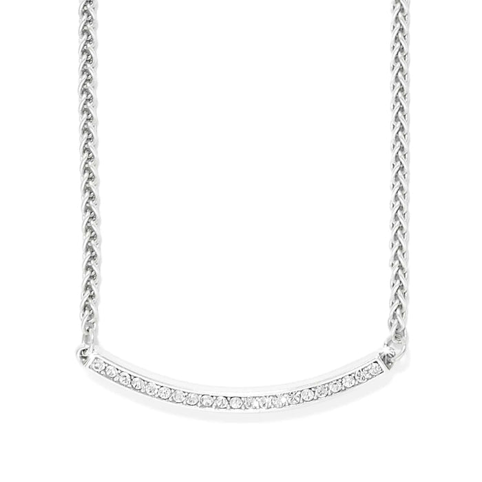 Brighton necklace with silver-plated wheat chain and curved crystal-set bar pendant on a white background