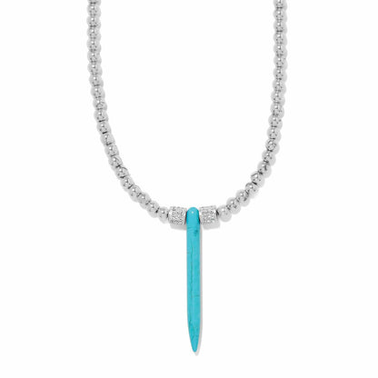 Brighton pendant necklace with silver-plated beaded chain, blue howlite turquoise spike, and crystal accents on a white background