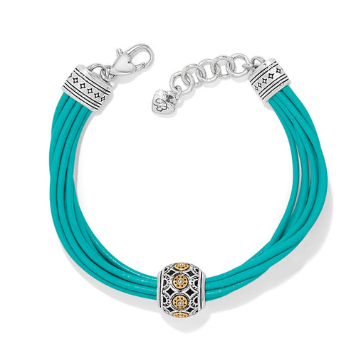 Brighton bracelet with teal leather cords and two-tone decorative bead featuring crystal accents on a white background