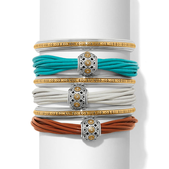 Brighton bangle and leather cord bracelet stack in turquoise, white, and brown with two-tone medallions on a white background