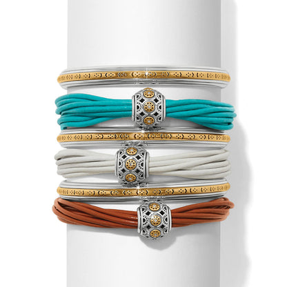 Brighton bangle and leather cord bracelet stack in turquoise, white, and brown with two-tone medallions on a white background