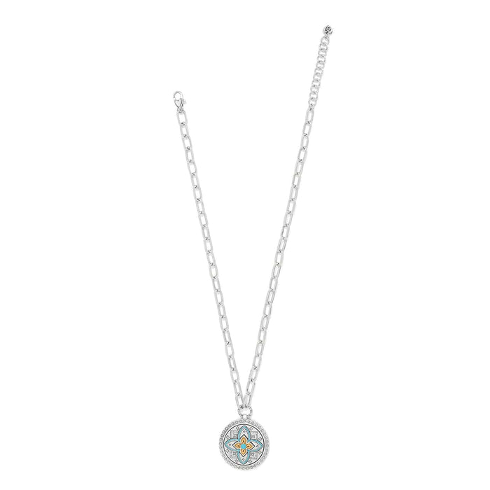 Brighton pendant necklace with two-tone medallion featuring turquoise enamel floral design and silver chain on a white background