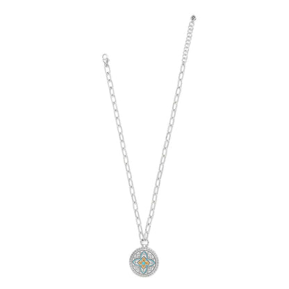 Brighton pendant necklace with two-tone medallion featuring turquoise enamel floral design and silver chain on a white background