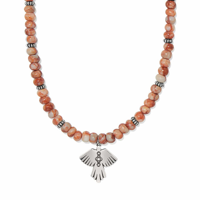 Brighton beaded necklace with orange marbled stones and silver-plated thunderbird pendant on a white background
