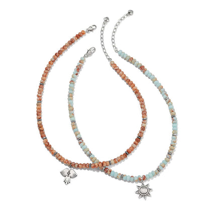 Brighton beaded necklaces with orange and aqua beads, silver-plated bird and star pendants on a white background