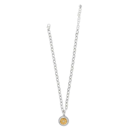 Brighton pendant necklace with two-tone round medallion, crystal center, and silver-tone chain on a white background