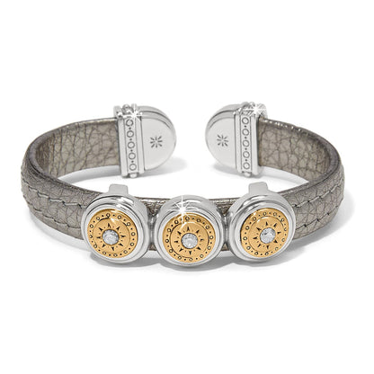 Brighton cuff bracelet with pewter leather band and three two-tone medallions with crystal centers on a white background