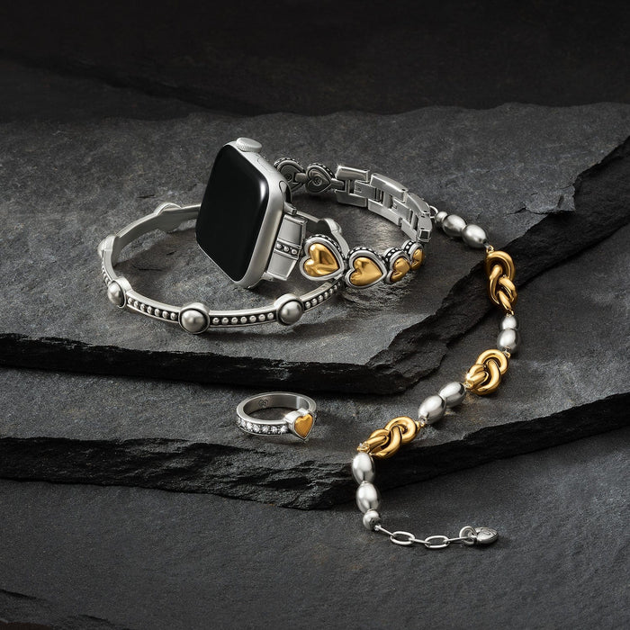 Brighton watch band styled with a two-tone heart bracelet, crystal heart ring, and beaded necklace on slate