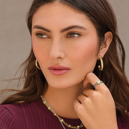 Model wearing Brighton two-tone crystal hoop earrings with coordinating Brighton accessories including a heart ring and layered necklace