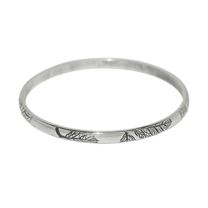 Brighton bangle bracelet with silver-plated finish and engraved leaf and branch detailing on a white background