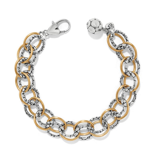 Brighton link bracelet with two-tone silver textured and gold smooth rings, lobster clasp, and bead charm on a white background