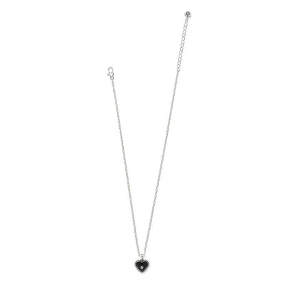 Brighton pendant necklace with silver-plated chain and black enamel heart pendant with crystal center on a white background