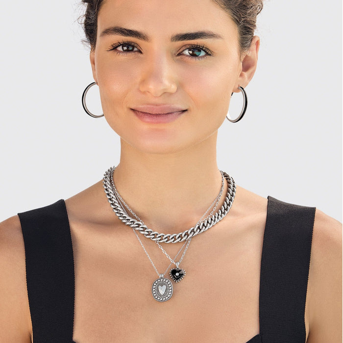Model wearing a Brighton silver-plated layered chain necklace with heart pendants and coordinating Brighton accessories