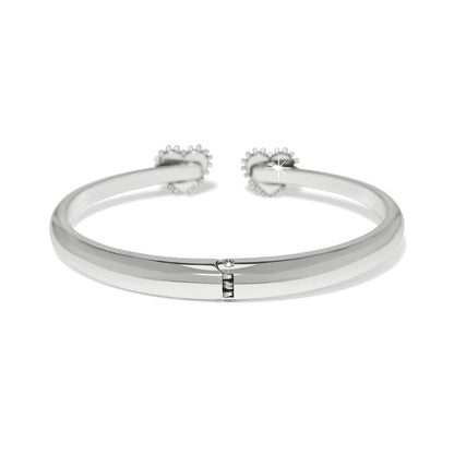 Brighton hinged cuff bracelet with silver-plated finish and two heart-shaped beaded end caps on a white background