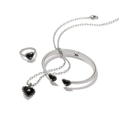 Brighton jewelry set with silver-plated bangle, ring, and heart pendant necklace featuring black hearts and crystals on a white background