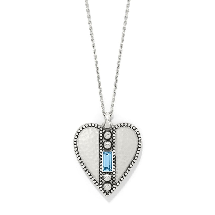 Brighton heart pendant necklace with hammered silver-plated finish, beaded edges, and blue crystal baguette on a white background