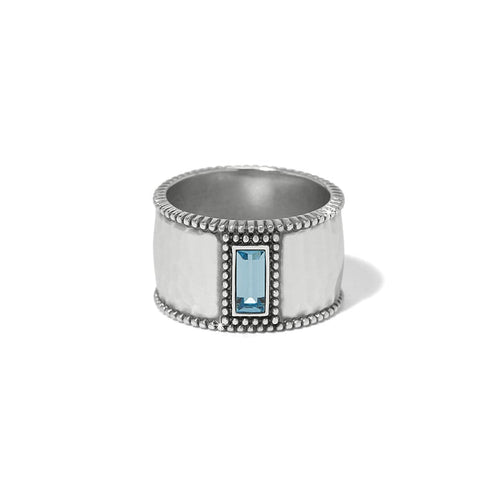 Brighton silver-plated wide band ring with hammered finish, beaded edges, and blue crystal baguette on a white background