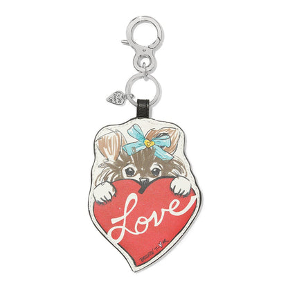 Brighton leather bag charm with illustrated puppy holding a red Love heart and silver-tone clasp on a white background