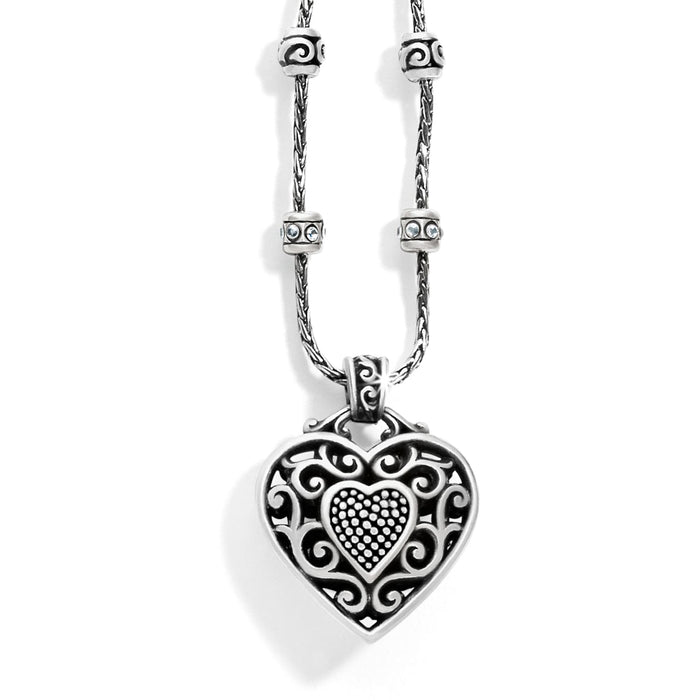 Brighton pendant necklace with silver-plated filigree heart, crystal-accented beaded stations, and rope chain on a white background