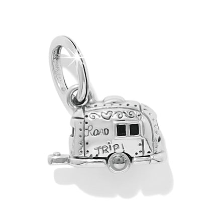 Brighton charm shaped like a silver-plated camper trailer with Road Trip engraving and enamel windows on a white background