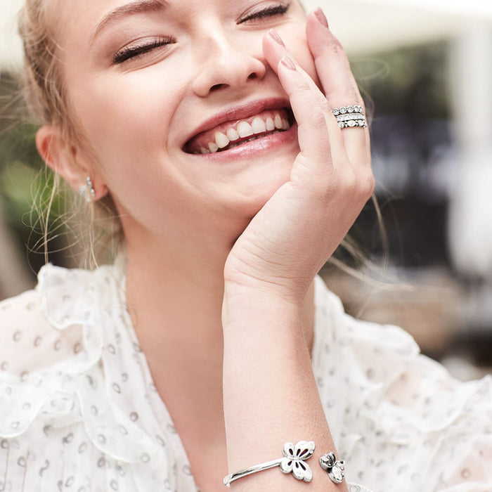 Model wearing Brighton silver-plated stacked rings with crystal accents and coordinating Brighton accessories including bracelet and earrings