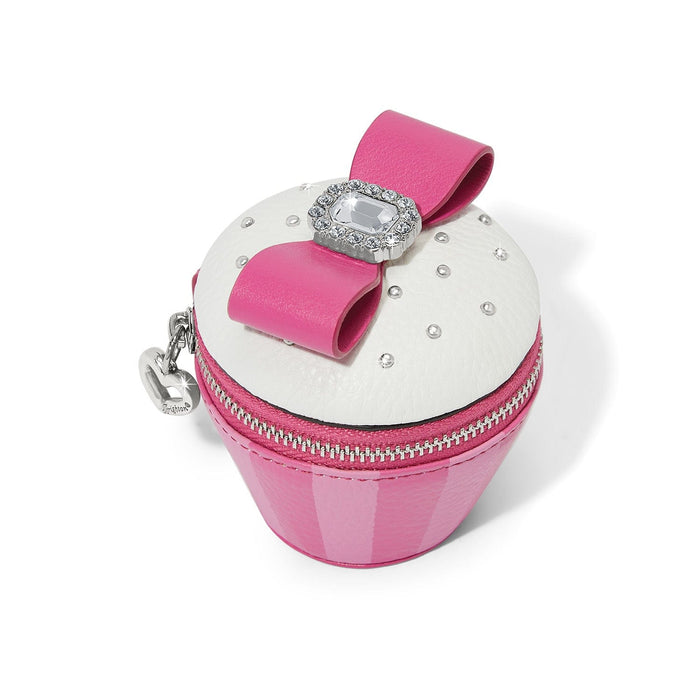 Brighton cupcake-shaped coin pouch with pink base, white top, leather bow, and crystal accents on a white background