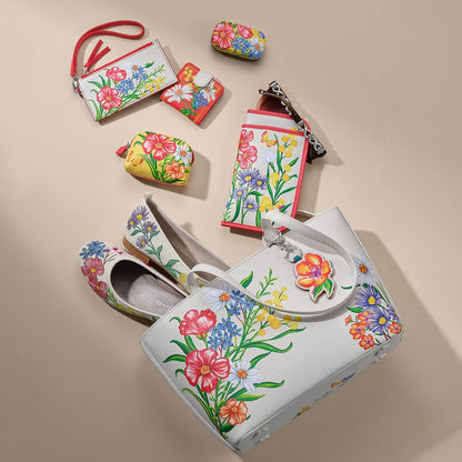 Brighton floral print handbag styled with matching wallets and ballet flats on a neutral background