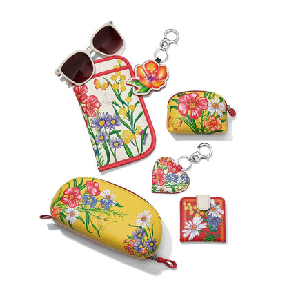 Brighton leather sunglasses case with floral print, styled with sunglasses and coordinating accessories on a white background