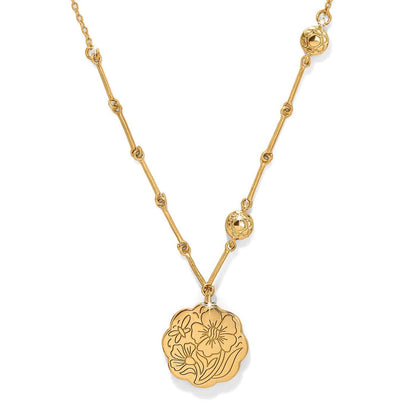 Brighton pendant necklace with gold-plated floral engraved medallion and decorative beaded chain on a white background