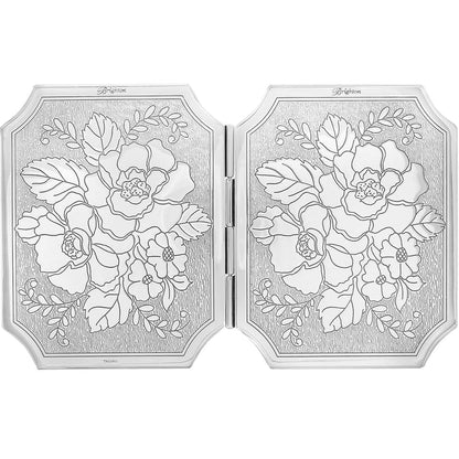 Brighton compact mirror shown open with silver-plated floral engraved design on both hinged panels on a white background