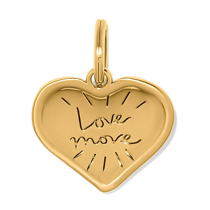 Brighton heart charm in gold-plated finish engraved with Love More script and radiating lines on a white background