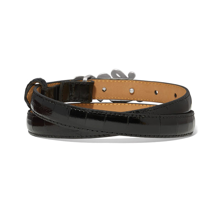 Brighton black croc-embossed leather belt coiled with silver-tone buckle and tan interior lining on a white background