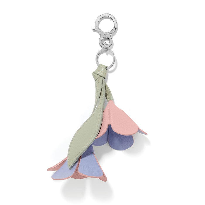 Brighton flower bag charm in pastel pink, lavender, and sage leather with silver-tone clasp on a white background