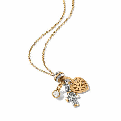 Brighton charm necklace with gold-tone heart, silver cross, crystal accent, and pavé bail on a white background