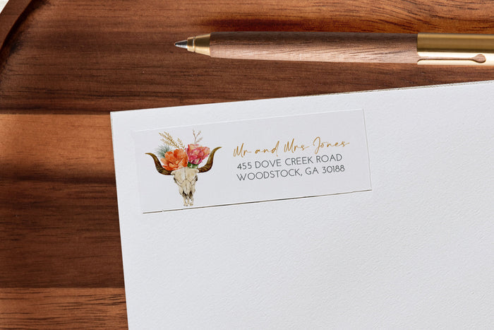 White stationery with a floral skull design on a wooden surface